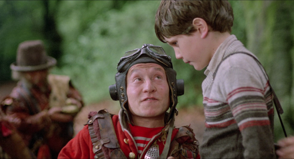 Randall (David Rappaport) breaks down the group's plans to Kevin (Craig Warnock) in Time Bandits (1981), HandMade Films