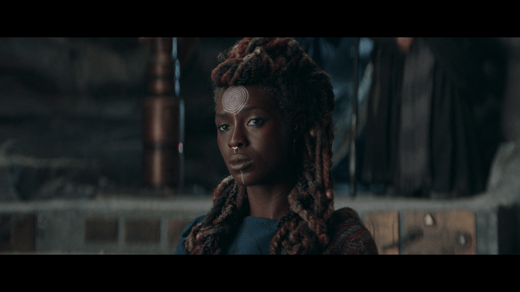 Aniseya (Jodie Turner-Smith) and Koril (Margarita Levieva) considers the Jedi's offer to train her daughters in The Acolyte Season 1 Episode 3 "Destiny" (2024), Disney