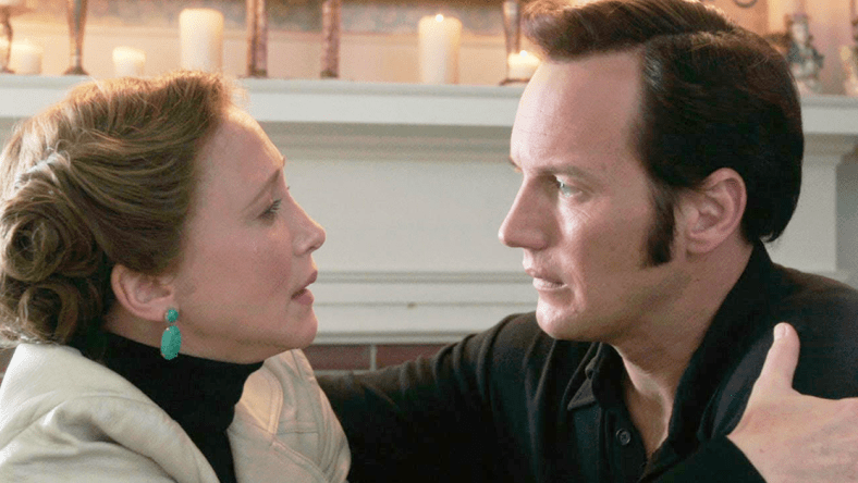 Lorraine Warren (Vera Farmiga) warns Ed (Patrick Wilson) of their next mission in The Conjuring 2 (2016), New Line Cinema