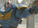 Titus (Clive Standen) draws his side arm in Warhammer 40,000: Space Marine 2 (2024), Saber Interactive