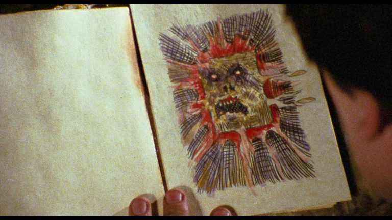 Ash (Bruce Campbell) gets his first look at the Necronomicon in The Evil Dead (1981), Renaissance Pictures