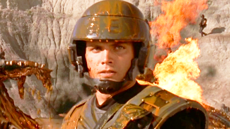 Johnny (Casper Van Dien) stands over a dead Bug in Starship Troopers (1997), Tri-Star Pictures