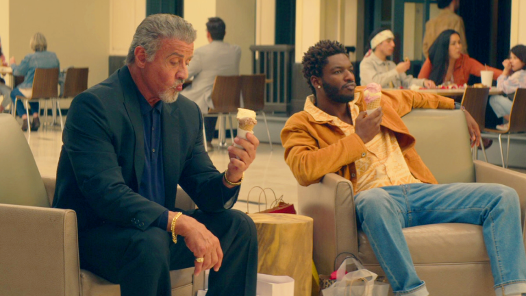 Dwight “The General” Manfredi (Sylvester Stallone) and Tyson (Jay Will) enjoy some ice cream in Tulsa King Season 1 Episode 1 "Go West, Old Man" (2022), Paramount