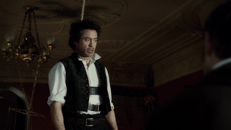Holmes (Robert Downey Jr.) attempts to deduce the circumstances behind a recent hanging in Sherlock Holmes (2009), Warner Bros. Pictures