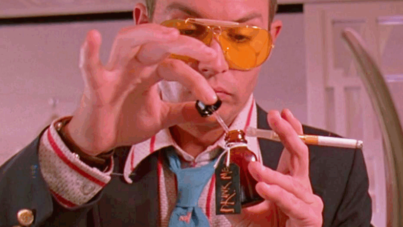 Raoul Duke (Johnny Depp) takes Dr. Gonzo's (Benicio Del Toro) medication advice in Fear and Loathing in Las Vegas (1998), Universal Pictures