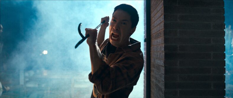 Scott Stanley (Justin Long) defends himself in Coyotes (2025), Aura Entertainment