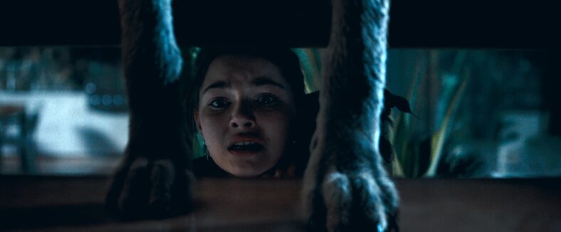 Chloe Stewart (Mila Harris) finds a place to hide in Coyotes (2025), Aura Entertainment