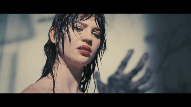 Iris (Sophie Thatcher) looking at her burnt arms in Companion (2025), Warner Bros. Pictures