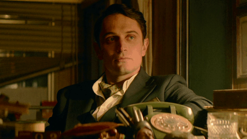 Winston (Colin Woodell) speaks with Charlie (Peter Greene) in The Continental: From the World of John Wick Episode 1 "Brothers in Arms" (2023), Lionsgate Television