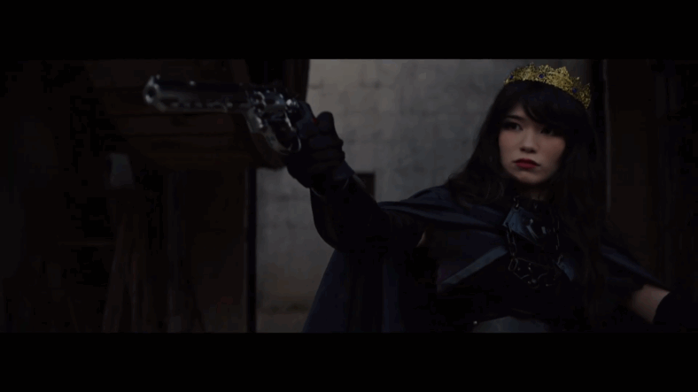 Emiru draws a gun while dressed as a queen promoting OTK via YouTube