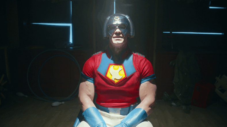 Peacemaker (John Cena) is seated for his interview with the Justice Gang in Peacemaker Season 2 Episode 1 "The Ties That Grind" (2025), DC Studios