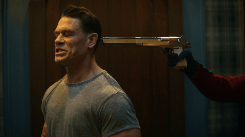 Peacemaker (John Cena) attempts to stammer out an apology for breaking and entering in Peacemaker Season 2 Episode 1 "The Ties That Grind" (2025), DC Studios