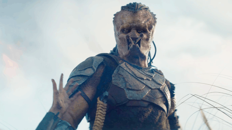 Thia (Elle Fanning) asks Dek (Dimitrius Schuster-Koloamatangi) for a helping hand in Predator: Badlands (2025), 20th Century Studios