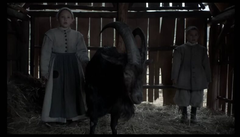 Mercy (Ellie Grainger), Jonas (Lucas Dawson), and Black Phillip (Charlie) in The VVitch (2015), A24