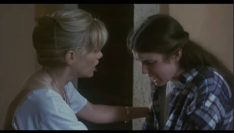 Rebecca (Jessica Dollarhide) tells her skeptical mother (Barbara Crampton)  that there's someone in the dungeons in Castle Freak (1995) Full Moon Entertainment