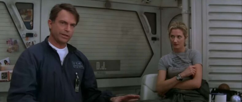 Dr, Weir (Sam Neil) patiently tries his best to explain how his ship works in Event Horizon (1997), Paramount Pictures