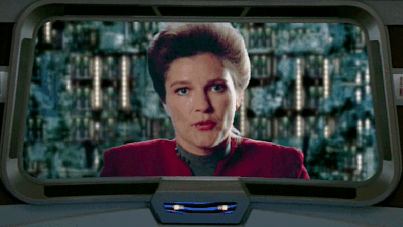 Captain Janeway (Kate Mulgrew) provides a status updates from the inside of the Borg Cube in Star Trek: Voyager Season 4 Episode 1 "Scorpion, Pt. 2" (1997), Paramount