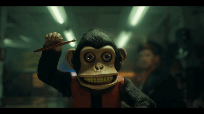 The Monkey bracing to start beating the drum at the antiquities shop in The Monkey (2025), C2/Atomic Monster/The Safran Company