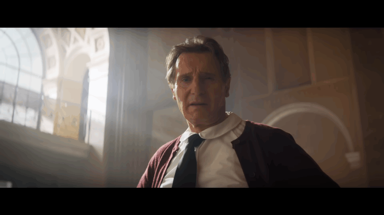 Frank Drebin Jr. (Liam Neeson) introduces himself to a group of hostages in The Naked Gun (2025), Paramount Pictures