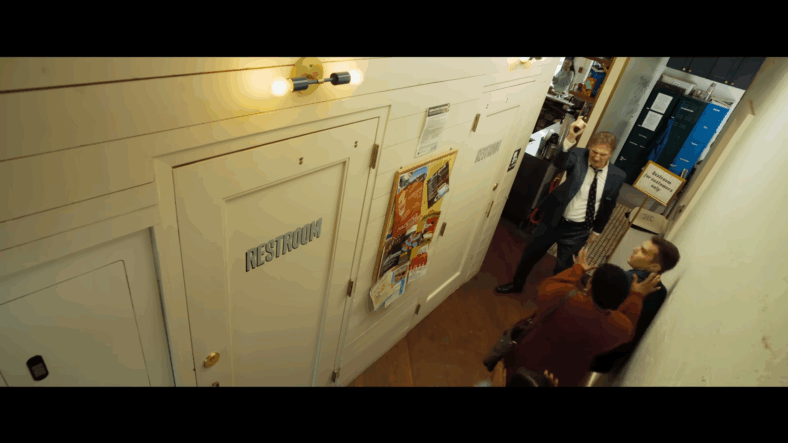 Frank Drebin Jr. (Liam Neeson) requests to use the restroom in The Naked Gun (2025), Paramount Pictures