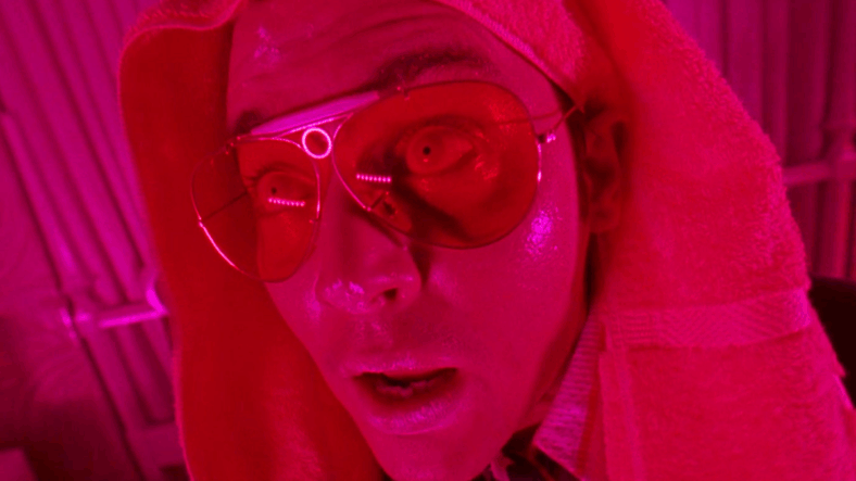 Raoul Duke (Johnny Depp) begins to freak out after taking a dropper of adrenochrome in Fear and Loathing in Las Vegas (1998), Universal Pictures