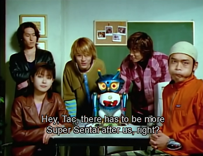 Sion (Masahiro Kuranuki) has a question for Tac (Yusuke Numata) in Mirai Sentai Timeranger Episode 51 "Super Sentai Big Gathering (Special Compilation)" (2001), Toei