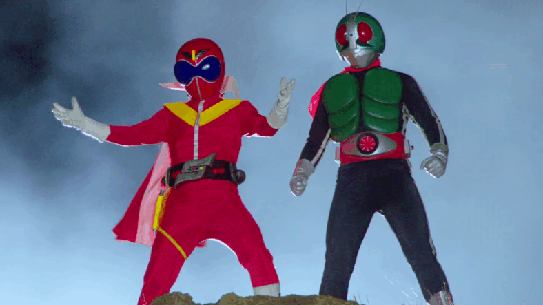 Akaranger (Tomokazu Seki) and Kamen Rider-1 (Tetsu Inada) arrive to the battle against Space Shocker with a colorful cast of reinforcements in Kamen Rider × Super Sentai × Space Sheriff Super Hero Taisen Z (2012), Toei Co. Ltd.