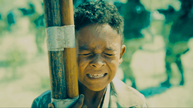 A young Jarhanpurian boy (AJ Bernard) receives a last minute save from Guy Gardner (Nathan Fillion) in Superman (2025), DC Studios