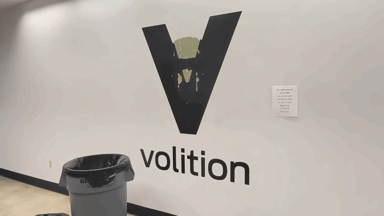 Volition's logo being torn off the wall of their office in My 2019 Visit to Volition & the Saints Row We Never Got (Part 1) (2025), YouTube