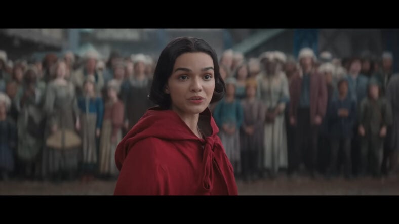 Snow White (Rachel Zegler) leads a protest outside of The Evil Queen's (Gal Gadot) castle in Snow White (2025), Disney