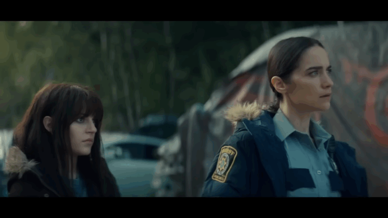 Martha Cypress (Romy Weltman) and Dana Cypress (Melanie Scrofano) watching Blaine Abel (Steven Ogg) preaching about the Revivers in Revival Season 1 Episode 4 "Run Along Little Lamb" (2025), Syfy