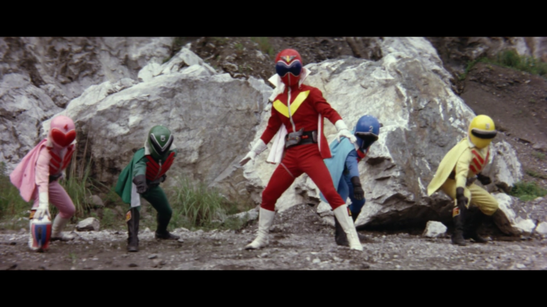 The team prepares to unleash their ultimate move, the Bomb Hurricane: All-Five Attack, against Steel Sword Dragon (Eiji Maruyama) in Himitsu Sentai Gorenger: The Bomb Hurricane (1976), Toei Co. Ltd.